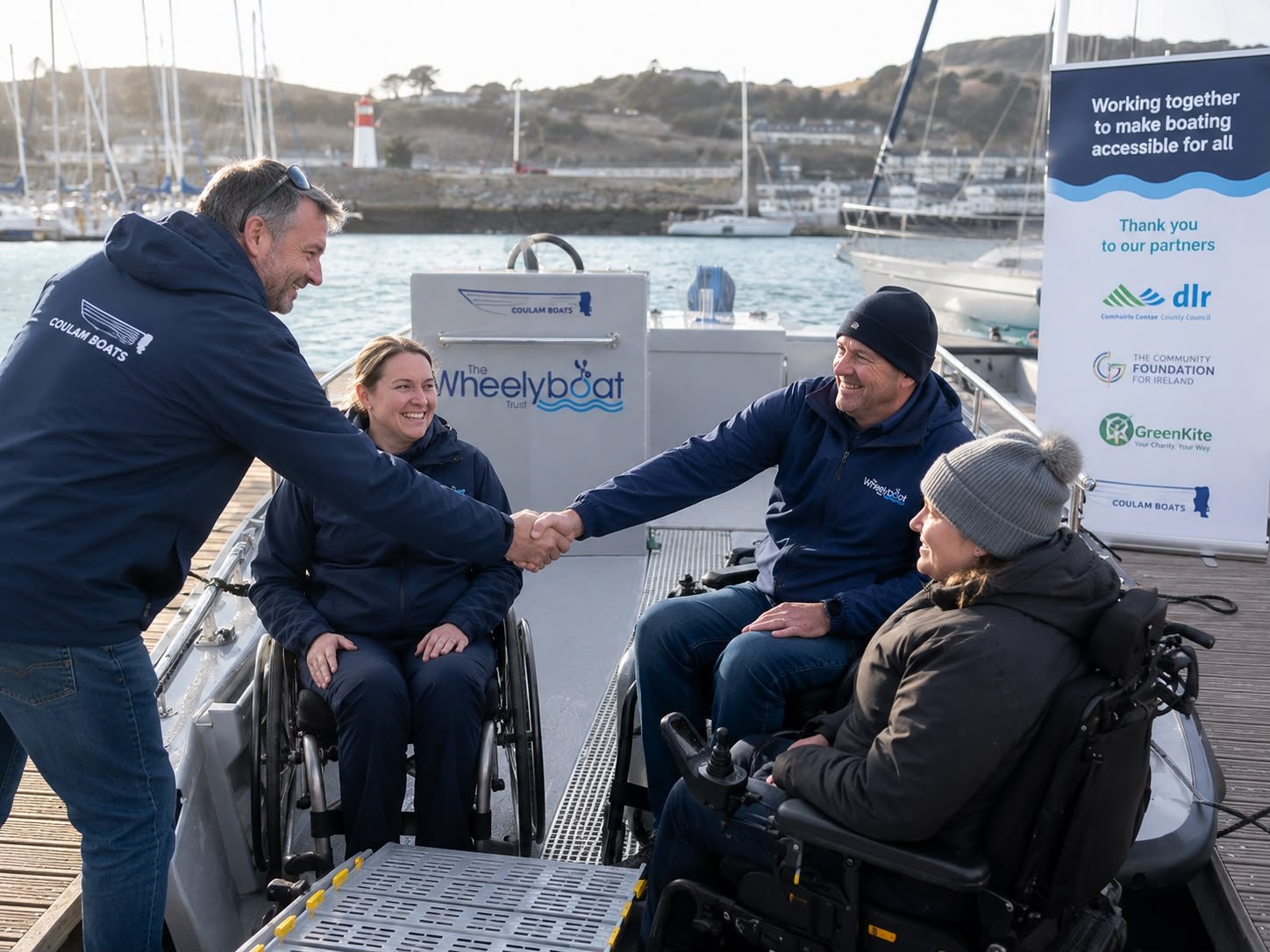 Small Overlay Image: BoatHub volunteers welcoming wheelchair users before an accessible boating trip.